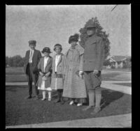 William "Babe" Bystle, Frances, Elizabeth, and Mary West, and an unidentified soldier stand in the front lawn of the West's house, Los Angeles, about 1916