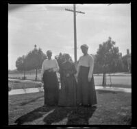 Wilhelmina West and Ida Teel stand on the West's front lawn with an unknown woman, Los Angeles, about 1914