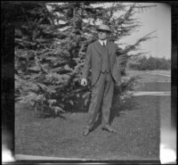 H. H. West poses on his front lawn, Los Angeles, about 1914
