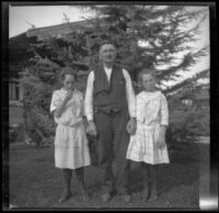 Elizabeth and Frances West stand on either side of their mother's uncle, Mr. Teel, Los Angeles, about 1915