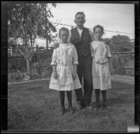 Frances and Elizabeth West stand on either side of their mother's uncle, Mr. Teel, Los Angeles, about 1915