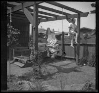 Elizabeth and Frances West play on a makeshift jungle gym in the West's backyard, Los Angeles, about 1915