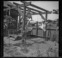 Elizabeth and Frances West play on a makeshift jungle gym in the West's backyard, Los Angeles, about 1915