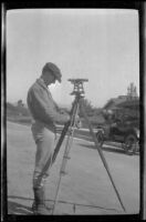 Man uses surveying equipment, Los Angeles, about 1916