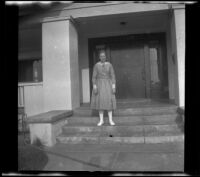 Frances West stands on the front steps of the West's house, Los Angeles, about 1920