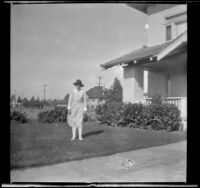 Mary West stands in the front lawn of her house at 1644 Wellington Road, Los Angeles, about 1920