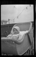 H. H. West Jr. in a baby carriage in the West's backyard, Los Angeles, about 1918