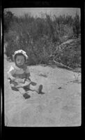 H. H. West Jr. sits in the sand, Los Angeles, about 1919