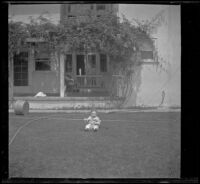 H. H. West Jr. sits in the West's backyard, Los Angeles, about 1918