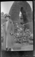 Mertie West stands in front of an arched hedge at the Hotel Del Monte, Monterey, 1924