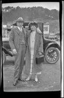 H. H. West and Mertie West pose with their arms around each other in front of a car, San Francisco, 1924