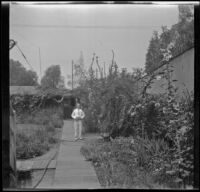 H. H. West Jr. stands in the West's backyard, Los Angeles, about 1932