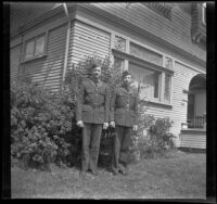 H. H. West Jr. and another man stand in front of the West's house wearing their R. O. T. C. uniforms, Los Angeles, about 1938
