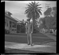 H. H. West Jr. stands in front of the West's home at 2223 Griffin Avenue wearing his army uniform, Los Angeles, 1940