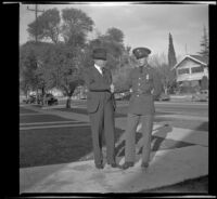 H. H. West Jr., in his army uniform, shakes hands with H. H. West, Los Angeles, 1940