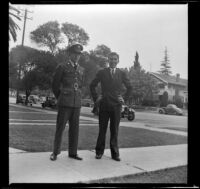 H. H. West Jr. and Richard West stand in front of the West's home at 2223 Griffin Avenue, Los Angeles, 1941