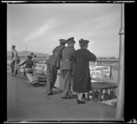 William Roscoe Wright, Gilbert Cecil West, and Mertie West lean on a railing on the Santa Monica pier, Santa Monica, 1941