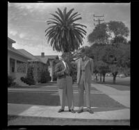 Gilbert Cecil West and his friend stand together laughing, Los Angeles, 1941