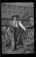 H. H. West stands in Dr. Bim Smith's backyard wearing a serape, Los Angeles, 1939