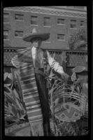 H. H. West stands in Dr. Bim Smith's backyard wearing a serape, Los Angeles, 1939