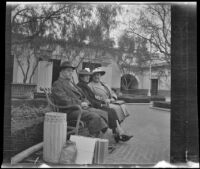 Fred and Mary Lemberger sit on a bench in front of Union Station with Bertha Vogel, Los Angeles, 1940