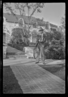 Evert West stands in front of Jack Benny's home, Beverly Hills, 1941