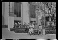 Myrtle and Evert West sit on a bench in front of Union Station, Los Angeles, 1941