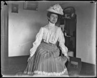 Mertie Whitaker in the parlor of the home of H. H. West, Los Angeles, circa 1900