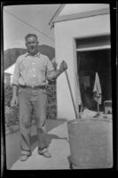 Al Siemsen poses while doing cement work at his home, Glendale, 1943