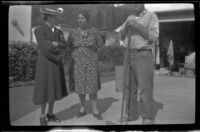 Mertie West, Elizabeth Siemsen and Al Siemsen stand in the driveway of the Siemsen's home, Glendale, 1943