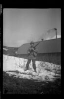 H. H. West, Jr. poses in the snow with a rifle, Dutch Harbor, 1943