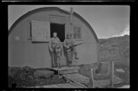 H. H. West, Jr. and a fellow serviceman pose with their rifles in front of the barracks, Dutch Harbor, 1943
