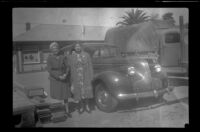 Mertie West and Elizabeth Siemsen stand next to a car outside the Southern Pacific Railroad depot (negative), San Luis Obispo, 1942