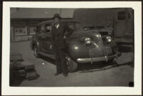 H. H. West poses in front of a car outside the Southern Pacific Railroad depot (photo, recto), San Luis Obispo, 1942