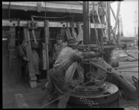 Workers on the drill floor an oil rig, probably at the Venice or Playa del Rey oil field, Los Angeles, 1930
