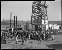 Crowd gathered at an oil well, probably at the Playa del Rey oil field, Los Angeles, 1930-1940