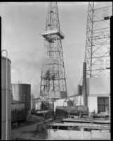 Oil derrick with a sign reading "M. C. R. R. Co. Ltd., Well No. 2" probably at the Venice oil field, Los Angeles, circa 1930