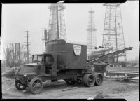 Maaco Construction Company truck crane parked at an oil field, Los Angeles, circa 1930