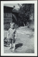 Dennis Albert Deaver stands in his grandparents' yard (photo, recto), Sierra Madre, 1943