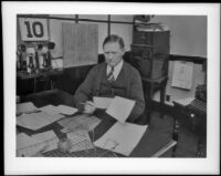 James A. Day sits at his desk in the Southern Pacific Railroad depot at Fifth and Central Avenues, Los Angeles, about 1939