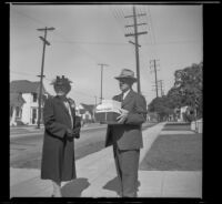 Josie Shaw and William Henry Shaw stand outside Asbury Methodist Church with their anniversary gifts, Los Angeles, 1944