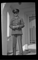 H. H. West, Jr. poses on the front porch of the West's residence, Los Angeles, 1944