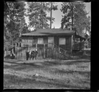 Wayne West, Maud West, Mertie West, Agnes Whitaker and Forrest Whitaker stand outside Doctor Ambrose Teel's cabin, Big Bear Lake, 1944