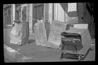 Four boxes of Stakmore folding chairs sit on the sidewalk outside the H. H. West Company, Los Angeles, 1945