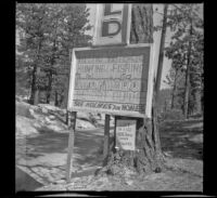 Holmes advertisement posted along the roadside near Boulder Bay, Big Bear Lake, 1945