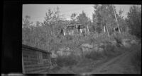 Worm's-eye view of a cabin standing behind the hotel at Circle Hot Springs, Circle vicinity, 1946