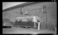 Trailer sitting behind a store, Anchorage, 1946