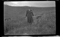 H. H. West poses by the dog kennels, Denali National Park and Preserve, 1946