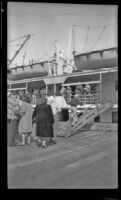 Mertie West walks up the gangplank to board a ship, Metlakatla, 1946