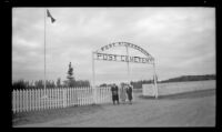 H. H. West, Frances Wells and Mertie West pose outside the front gate of Fort Richardson Post Cemetery, Fort Richardson, 1946